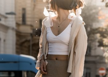 a woman is standing on a skateboard on the street