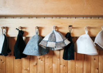 a row of towels hanging on a wooden wall