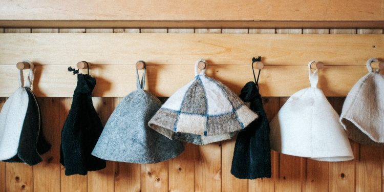 a row of towels hanging on a wooden wall