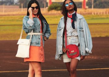 two women standing on sports field during daytime