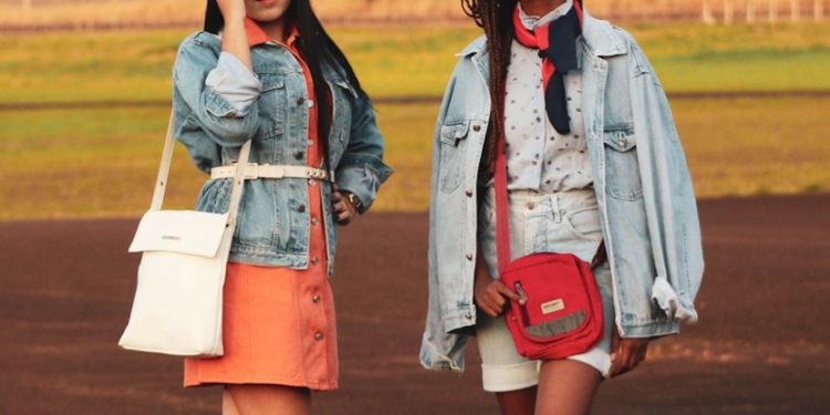 two women standing on sports field during daytime