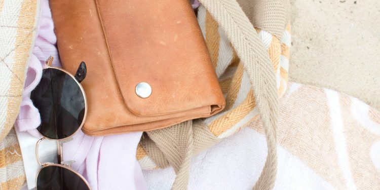 brown leather shoulder bag with dark sunglasses