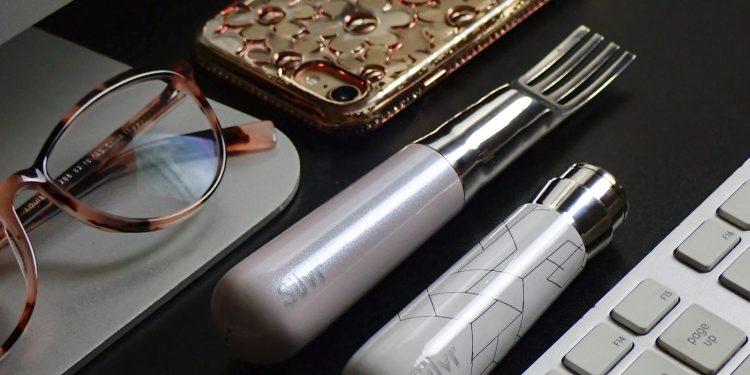 silver and black tube type vape beside brown leather pouch