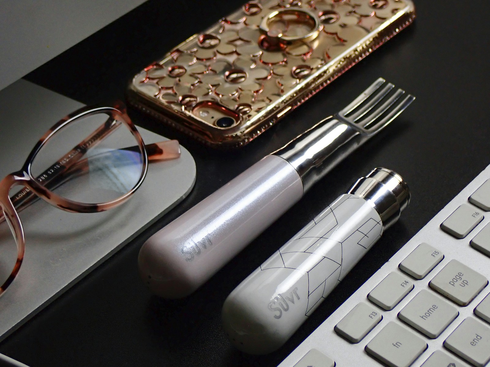 silver and black tube type vape beside brown leather pouch