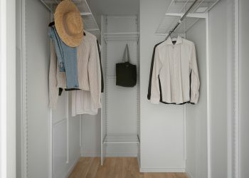 A white closet with a hat and coat rack