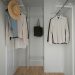 A white closet with a hat and coat rack