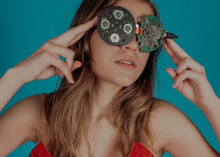 woman covering her eyes with circuit boards