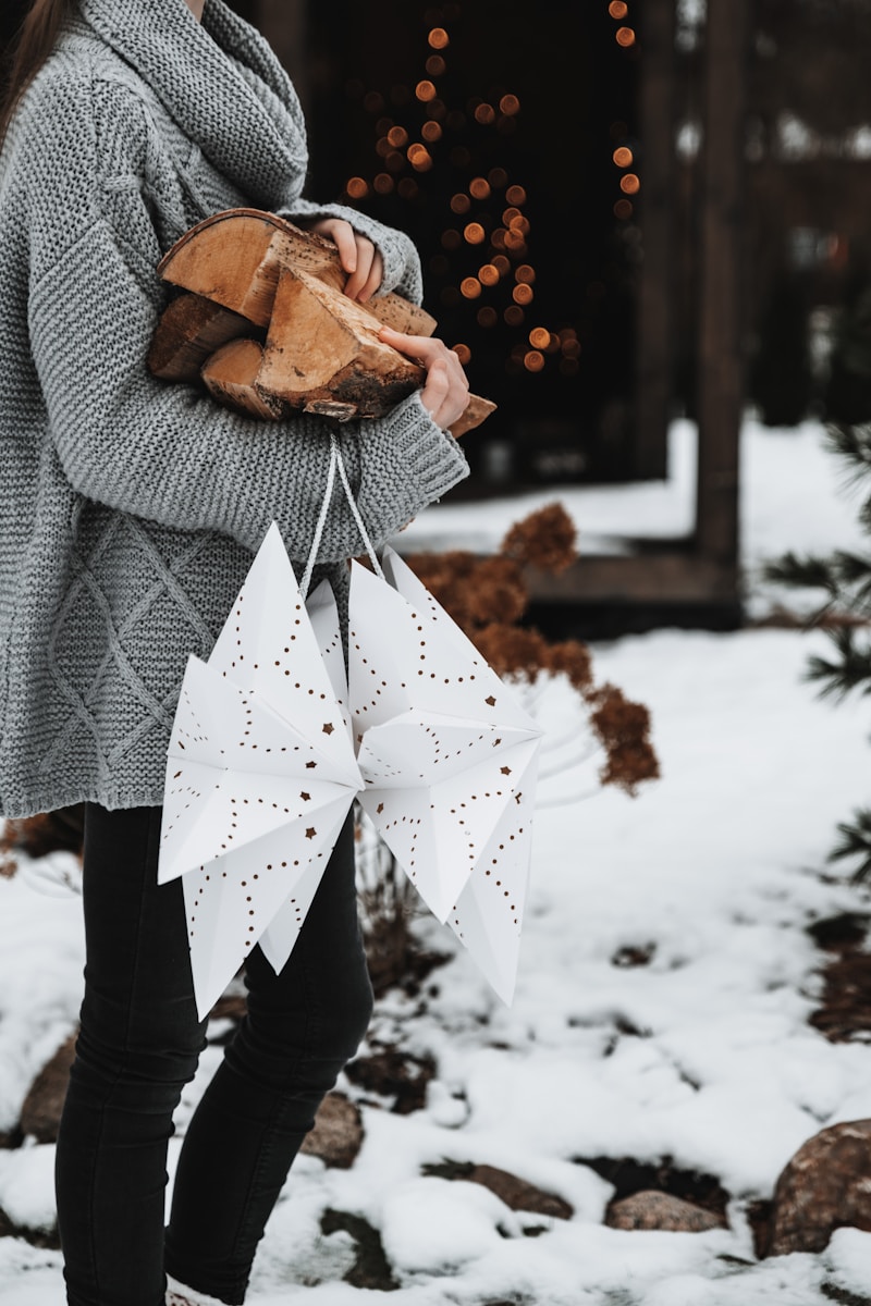 a woman in a gray sweater holding a bag